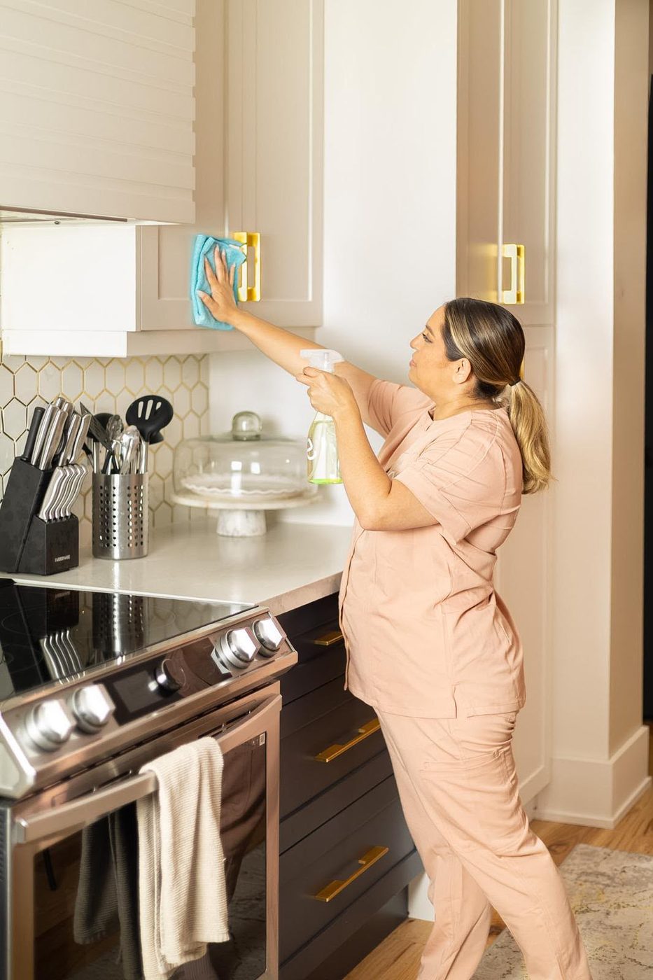Wiping down kitchen cabinets